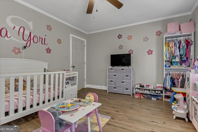 2715 N Doublegate Dr, Albany, GA 31721 - bedroom featuring crown molding, a crib, wood finished floors, and ceiling fan