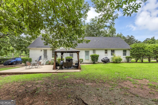 2715 N Doublegate Dr, Albany, GA 31721 - rear view of house featuring a gazebo, a lawn, brick siding, a patio area, and roof with shingles