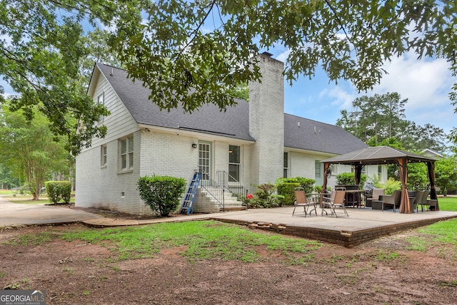 2715 N Doublegate Dr, Albany, GA 31721 - back of property with a gazebo, brick siding, a chimney, a shingled roof, and a patio area