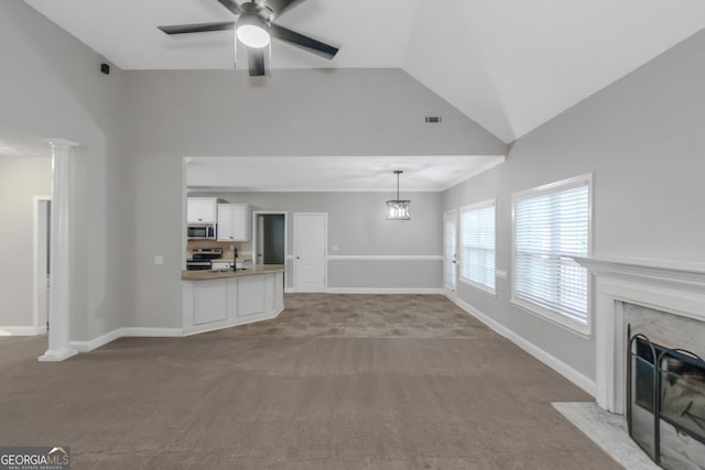 185 Stewart Glen Dr, Covington, GA 30014 - unfurnished living room with carpet flooring, a ceiling fan, a premium fireplace, high vaulted ceiling, and a sink