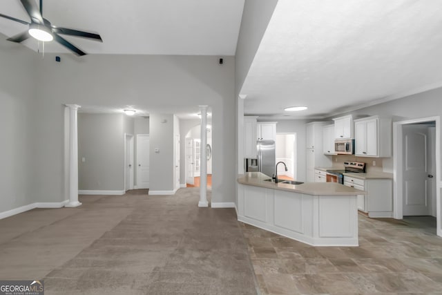 185 Stewart Glen Dr, Covington, GA 30014 - kitchen featuring appliances with stainless steel finishes, a sink, ceiling fan, light countertops, and baseboards