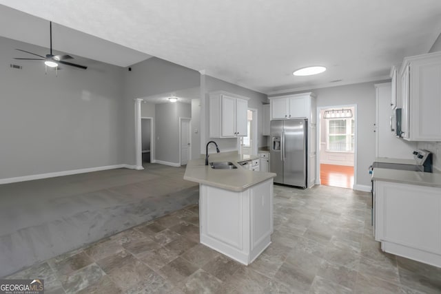 185 Stewart Glen Dr, Covington, GA 30014 - kitchen with stainless steel appliances, a ceiling fan, baseboards, a peninsula, and open floor plan