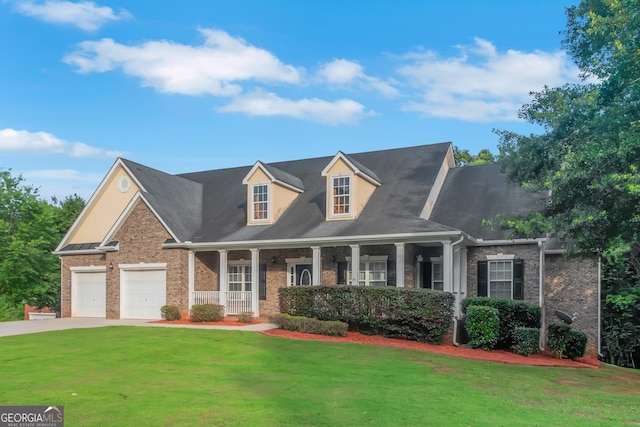 185 Stewart Glen Dr, Covington, GA 30014 - new england style home with a porch, a front lawn, driveway, brick siding, and an attached garage