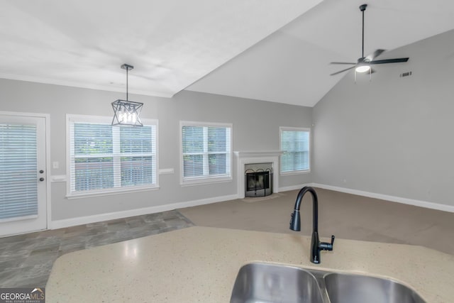 185 Stewart Glen Dr, Covington, GA 30014 - kitchen featuring a sink, a fireplace with flush hearth, plenty of natural light, and light stone counters