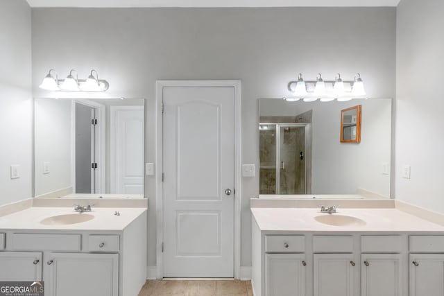 185 Stewart Glen Dr, Covington, GA 30014 - bathroom with a stall shower, two vanities, and tile patterned flooring