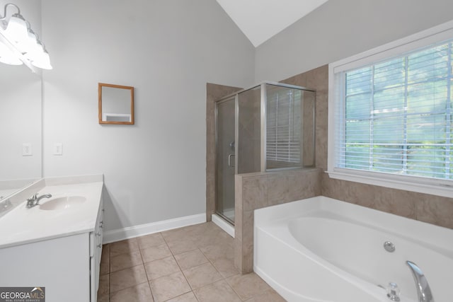 185 Stewart Glen Dr, Covington, GA 30014 - full bathroom featuring vanity, vaulted ceiling, a bath, a stall shower, and tile patterned flooring