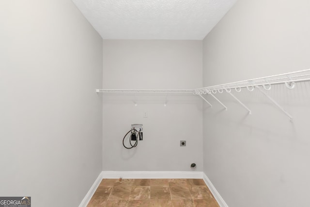 185 Stewart Glen Dr, Covington, GA 30014 - washroom with washer hookup, hookup for an electric dryer, baseboards, and a textured ceiling