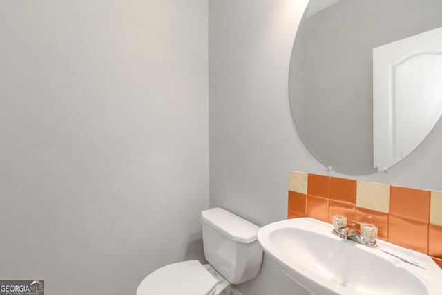 185 Stewart Glen Dr, Covington, GA 30014 - half bathroom featuring toilet and a sink