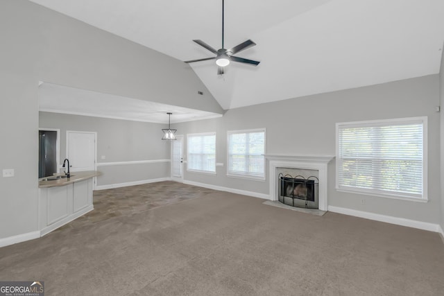 185 Stewart Glen Dr, Covington, GA 30014 - unfurnished living room with carpet flooring, a fireplace with flush hearth, ceiling fan, baseboards, and high vaulted ceiling