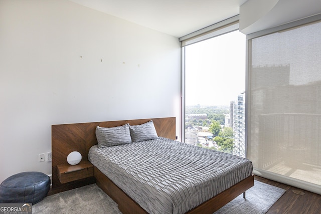 1080 Peachtree St NE Unit 2116, Atlanta, GA 30309 - bedroom with a wall of windows and wood finished floors
