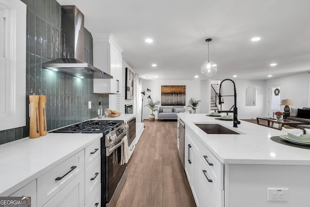 1536 Daffodil Dr, Marietta, GA 30062 - kitchen with wall chimney exhaust hood, open floor plan, appliances with stainless steel finishes, a sink, and recessed lighting