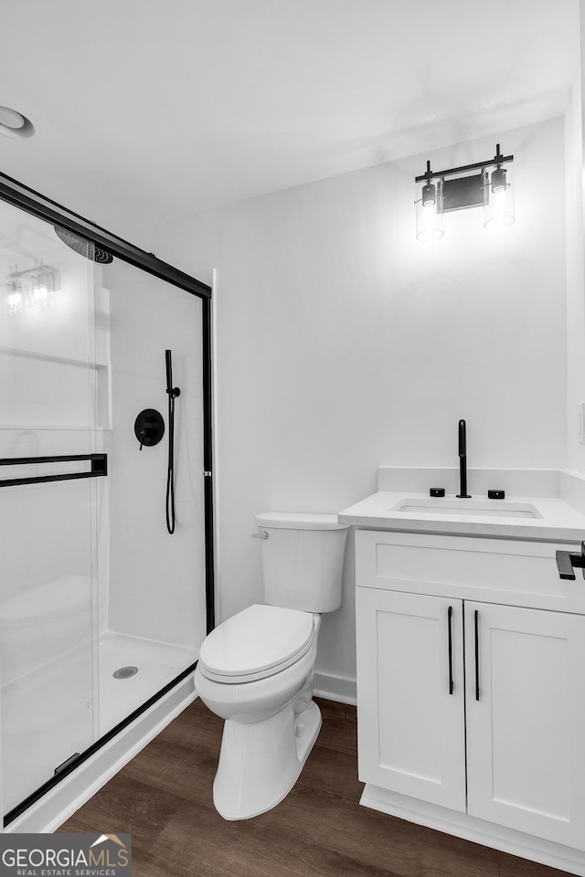 1536 Daffodil Dr, Marietta, GA 30062 - full bathroom with a shower stall, toilet, wood finished floors, and vanity
