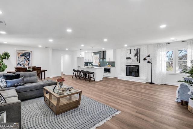 1536 Daffodil Dr, Marietta, GA 30062 - living area with light wood-type flooring, recessed lighting, baseboards, and a fireplace