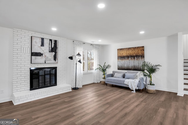 1536 Daffodil Dr, Marietta, GA 30062 - living area with wood finished floors, a brick fireplace, baseboards, recessed lighting, and stairs
