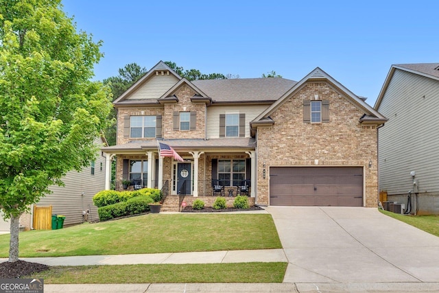 406 Fernstone Dr, Canton, GA 30114 - craftsman house featuring a porch, concrete driveway, a front yard, a garage, and brick siding