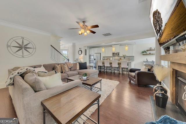 406 Fernstone Dr, Canton, GA 30114 - living room featuring ornamental molding, a ceiling fan, stairway, dark wood finished floors, and a fireplace with raised hearth