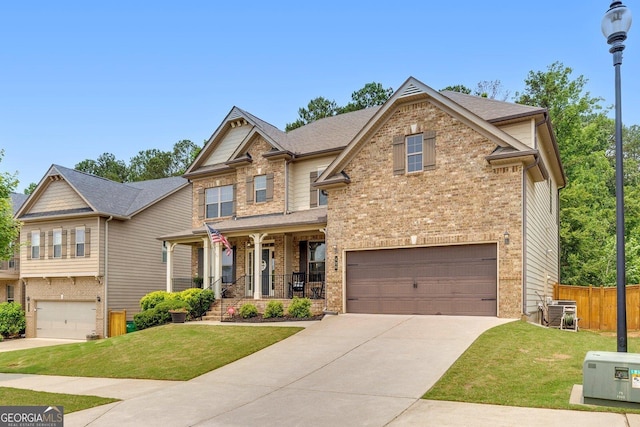 406 Fernstone Dr, Canton, GA 30114 - craftsman-style home with an attached garage, covered porch, concrete driveway, and brick siding