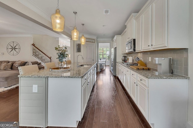 406 Fernstone Dr, Canton, GA 30114 - kitchen featuring appliances with stainless steel finishes, a sink, crown molding, dark wood-type flooring, and white cabinetry