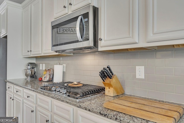 406 Fernstone Dr, Canton, GA 30114 - kitchen featuring appliances with stainless steel finishes, white cabinetry, decorative backsplash, and light stone counters