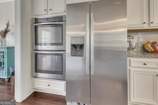 406 Fernstone Dr, Canton, GA 30114 - kitchen featuring stainless steel appliances, light stone counters, tasteful backsplash, and white cabinetry