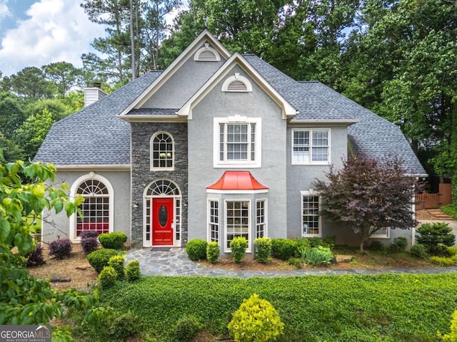 570 Hunt River Way, Suwanee, GA 30024 - view of front of property with a chimney, stucco siding, stone siding, and a shingled roof