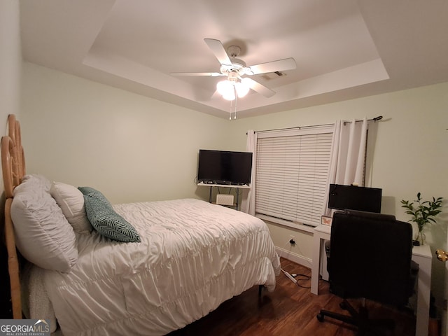 105 Deer Forest Trl, Macon, GA 31216 - bedroom with a tray ceiling, dark wood-style floors, a ceiling fan, and a desk