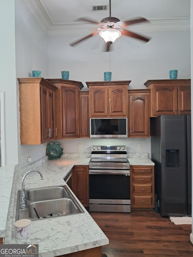 105 Deer Forest Trl, Macon, GA 31216 - kitchen featuring stainless steel appliances, a sink, a ceiling fan, ornamental molding, and light countertops