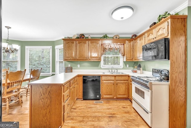 241 Tweed Ct, Sugar Hill, GA 30518 - kitchen with black appliances, a peninsula, crown molding, light countertops, and a chandelier