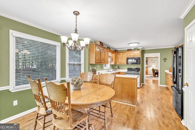 241 Tweed Ct, Sugar Hill, GA 30518 - dining room with a chandelier, light wood finished floors, and ornamental molding