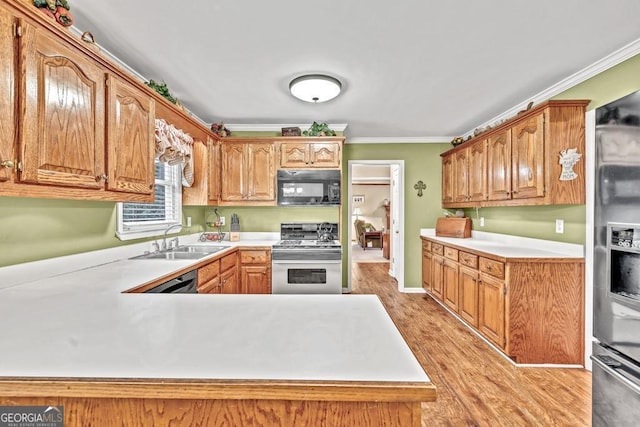 241 Tweed Ct, Sugar Hill, GA 30518 - kitchen featuring stainless steel appliances, light countertops, crown molding, light wood-style floors, and a peninsula
