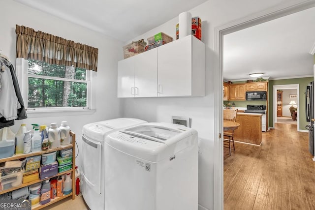 241 Tweed Ct, Sugar Hill, GA 30518 - laundry area featuring cabinet space, washer and dryer, and light wood-style floors