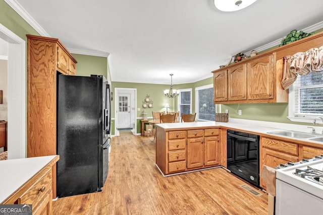241 Tweed Ct, Sugar Hill, GA 30518 - kitchen featuring black appliances, light wood-style flooring, a peninsula, a chandelier, and healthy amount of natural light