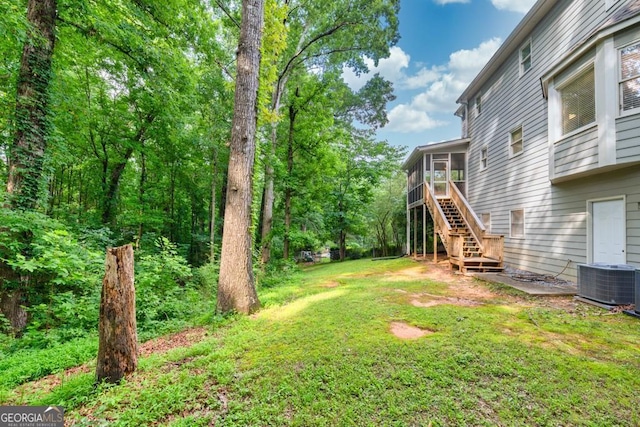 241 Tweed Ct, Sugar Hill, GA 30518 - view of green lawn with a sunroom and stairway