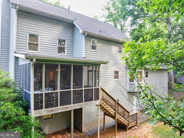 241 Tweed Ct, Sugar Hill, GA 30518 - rear view of house with a sunroom, a shingled roof, and stairway