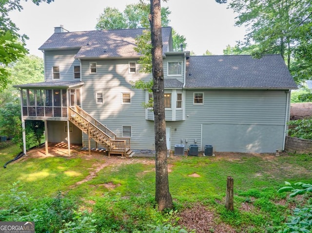 241 Tweed Ct, Sugar Hill, GA 30518 - rear view of house featuring a sunroom, a lawn, stairway, and a shingled roof