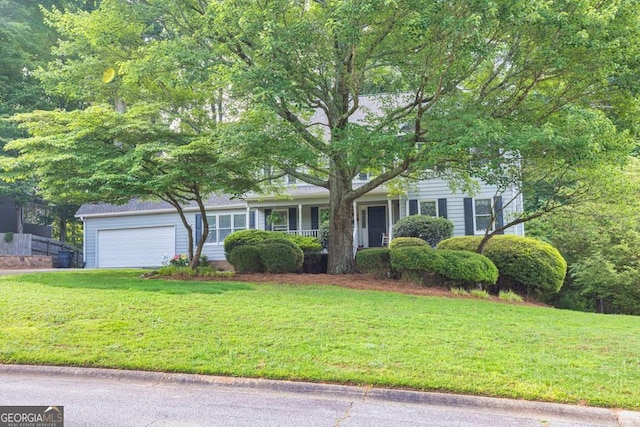 241 Tweed Ct, Sugar Hill, GA 30518 - view of front of property with a front yard, an attached garage, and covered porch