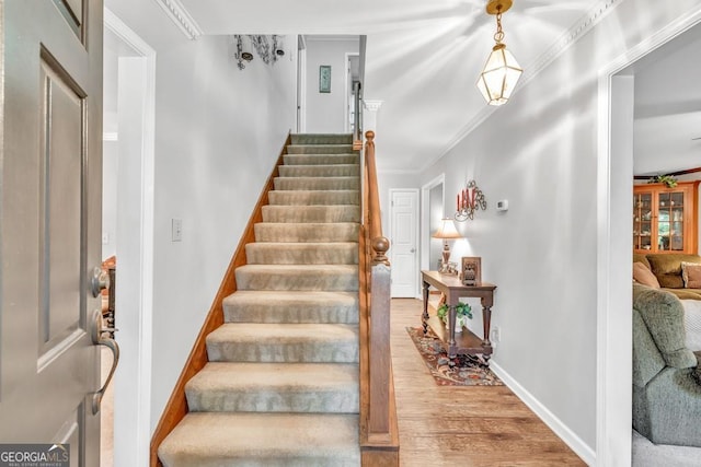 241 Tweed Ct, Sugar Hill, GA 30518 - stairway with wood finished floors and ornamental molding