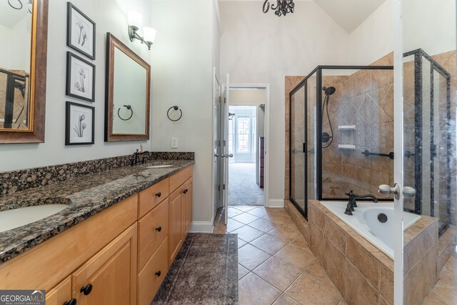 300 Brackin Trce, Grayson, GA 30017 - bathroom featuring a shower stall, double vanity, a bath, tile patterned flooring, and lofted ceiling