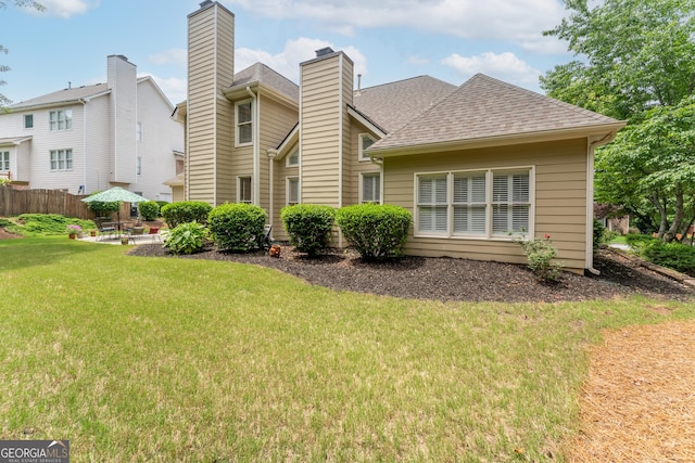 300 Brackin Trce, Grayson, GA 30017 - rear view of property featuring roof with shingles, a chimney, and a patio
