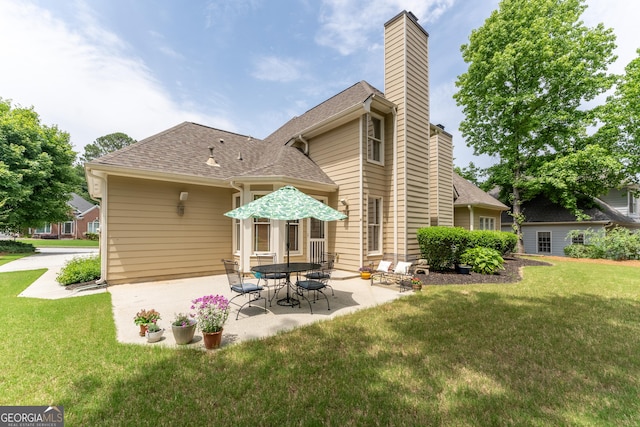 300 Brackin Trce, Grayson, GA 30017 - back of house with a patio area, a chimney, a yard, and roof with shingles