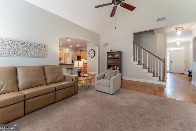 300 Brackin Trce, Grayson, GA 30017 - living room featuring light colored carpet, a ceiling fan, stairway, high vaulted ceiling, and arched walkways