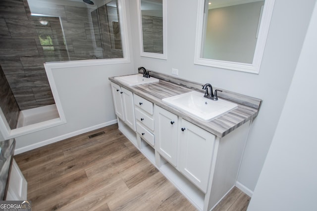74 Preacher Smith Rd SE, Silver Creek, GA 30173 - bathroom with double vanity, a walk in shower, wood finished floors, and baseboards
