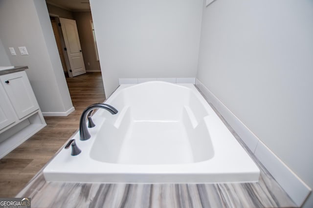 74 Preacher Smith Rd SE, Silver Creek, GA 30173 - full bathroom featuring a bath, vanity, and wood finished floors