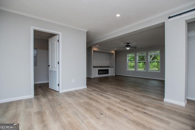 74 Preacher Smith Rd SE, Silver Creek, GA 30173 - unfurnished living room featuring ornamental molding, a ceiling fan, a fireplace, baseboards, and light wood-style flooring