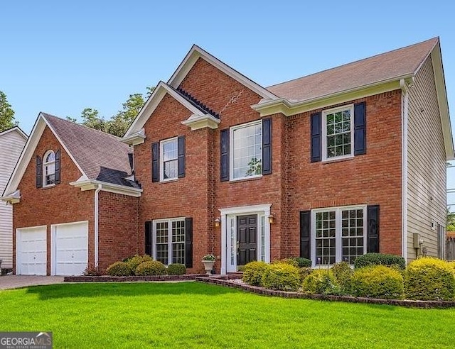 1713 Paramore Pl NE, Marietta, GA 30062 - colonial inspired home featuring brick siding, a garage, a front lawn, and driveway