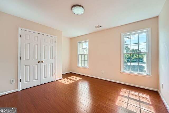 1713 Paramore Pl NE, Marietta, GA 30062 - unfurnished bedroom featuring wood finished floors and a closet