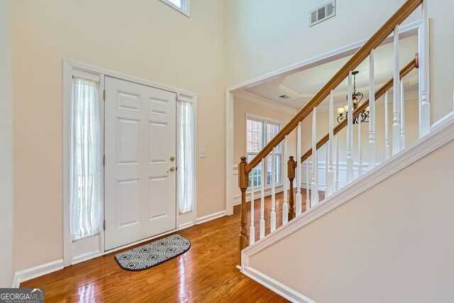 1713 Paramore Pl NE, Marietta, GA 30062 - foyer entrance featuring crown molding, wood finished floors, stairs, and a high ceiling
