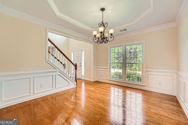 1713 Paramore Pl NE, Marietta, GA 30062 - spare room with stairs, a chandelier, wainscoting, wood finished floors, and crown molding