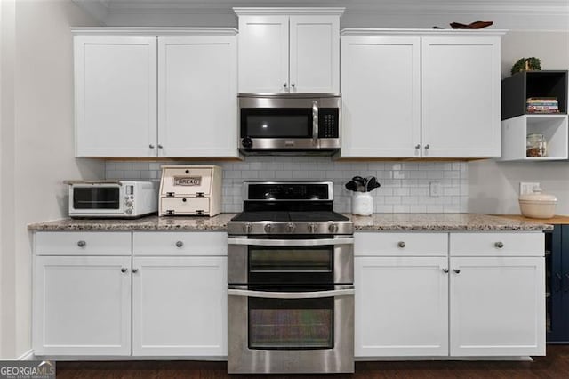 17 Twelve Oaks Dr, Cartersville, GA 30120 - kitchen with stainless steel appliances, white cabinetry, decorative backsplash, crown molding, and light stone counters