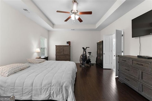 17 Twelve Oaks Dr, Cartersville, GA 30120 - bedroom featuring a tray ceiling, dark wood-style flooring, ceiling fan, and baseboards